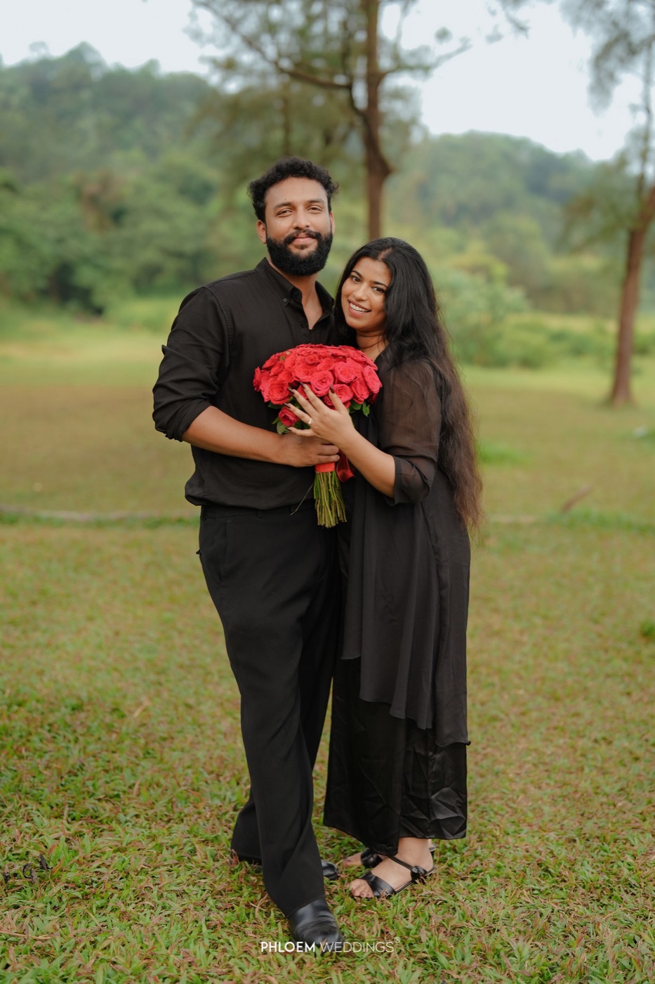 Amal and Angel holding red roses